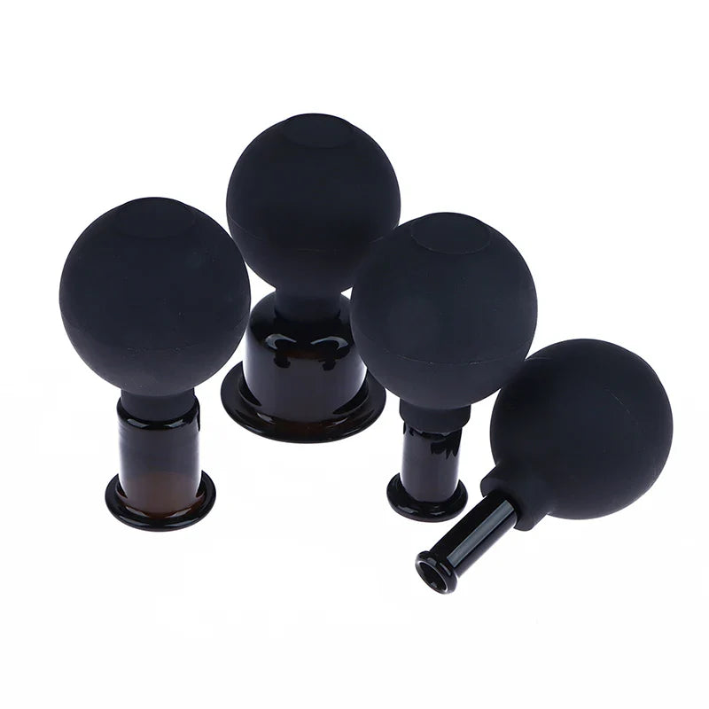 Lot de 4 ventouses anti-cellulites noires en silicone, de forme ronde et ergonomique, avec finition lisse et brillante.