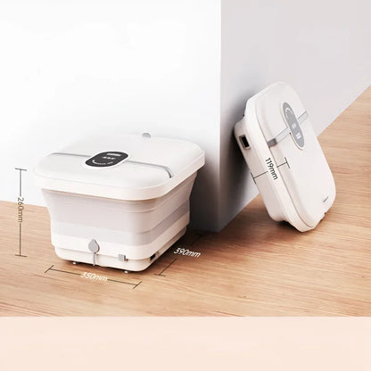 Bain de pied - Bassin pliable électrique avec massage et chauffage – vue générale du produit plié, couleur blanche sur un sol en bois