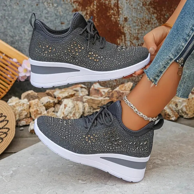 Basket orthopédique femme - Sneakers compensées noires en mesh avec strass, portées avec un jean, vue de côté mettant en avant la semelle ergonomique