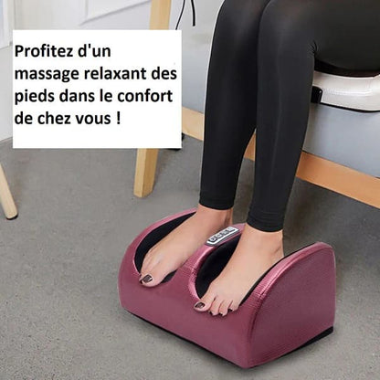 Masseur électrique Shiatsu pour les pieds - Vue générale avec un utilisateur en position assise, pieds posés sur l'appareil rose.
