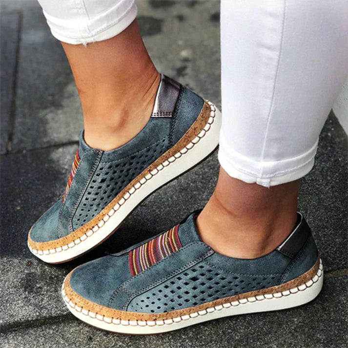 ADINA™ | Baskets orthopédiques confortables et élégantes – Baskets en cuir bleu avec perforations et détails colorés, portées avec un pantalon blanc